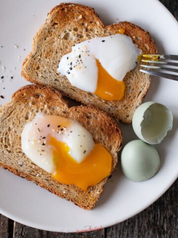 Sous vide eggs on toast, broken to show the runny yolk