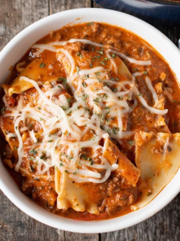 One Pot Lasagna Soup in a white bowl. square image close shot